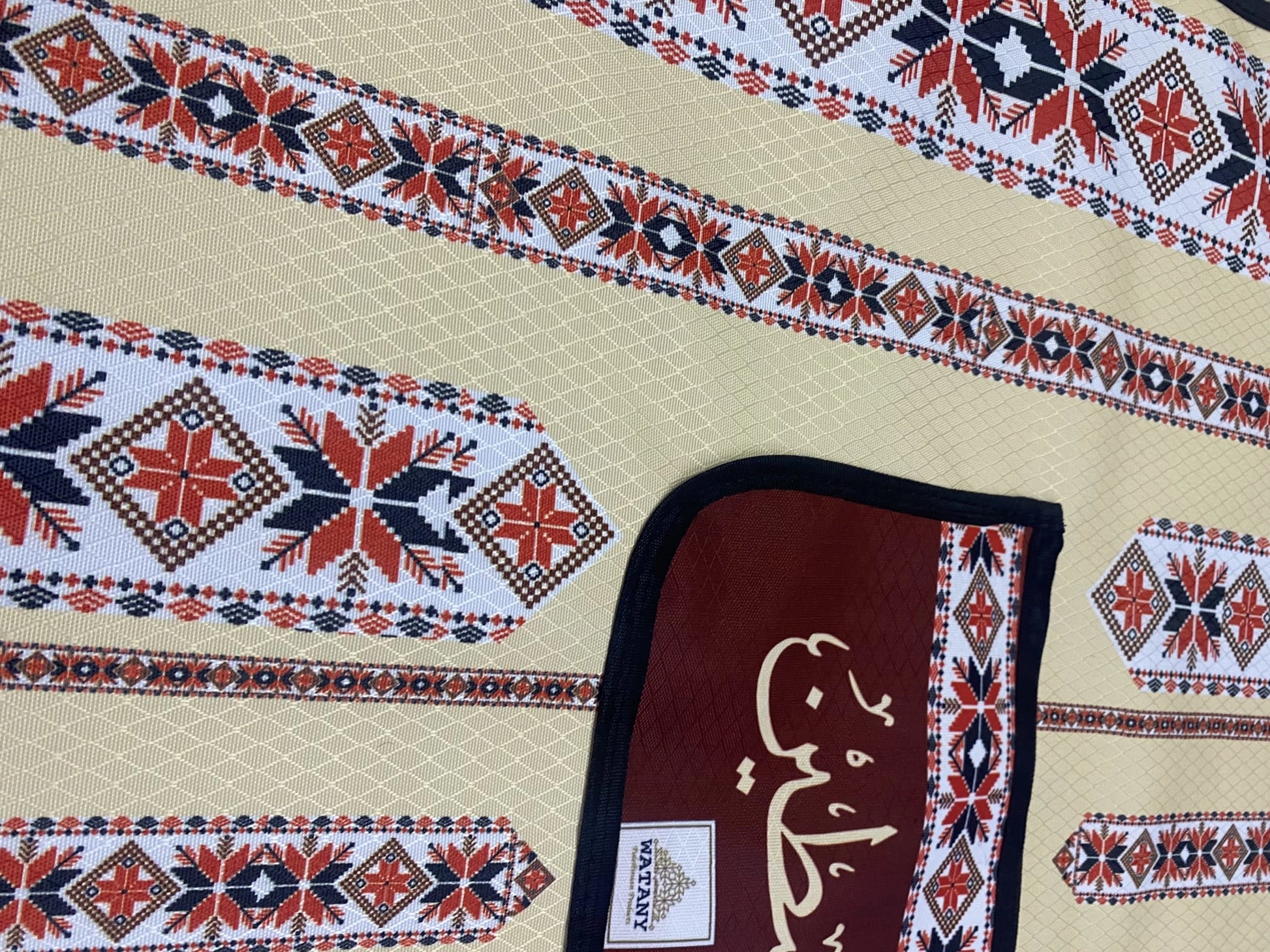 Decorative mat with geometric patterns and a brand label on a beige background