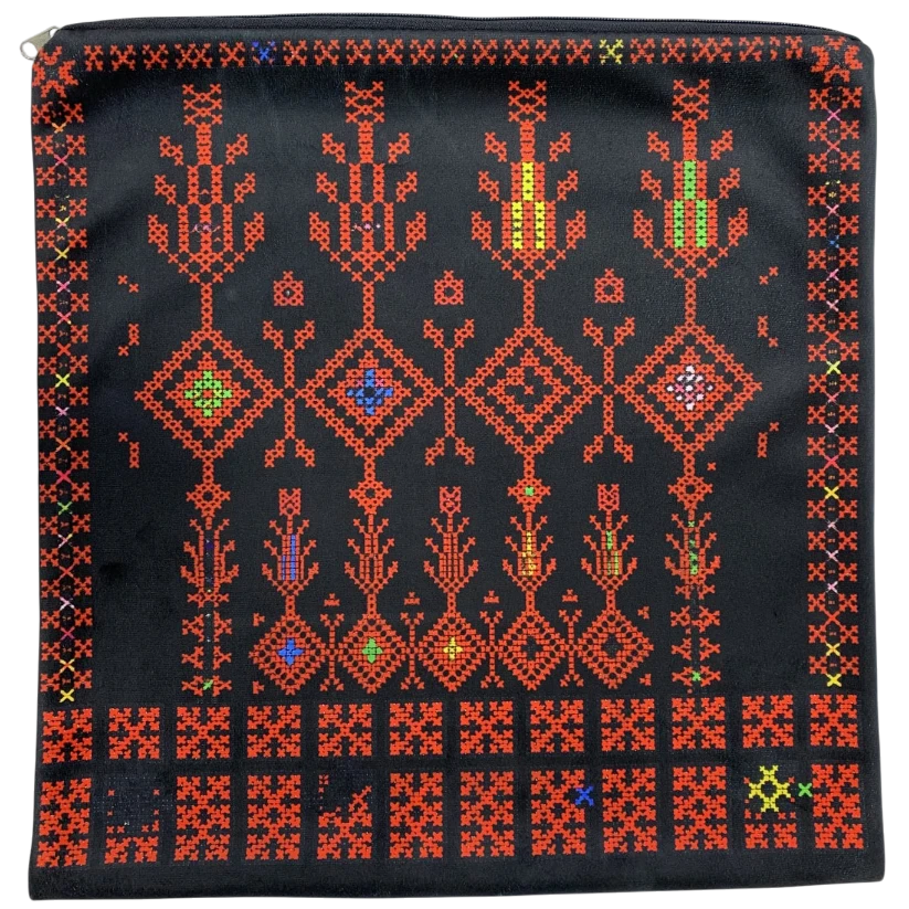 A square black zippered pouch featuring a vibrant, traditional geometric cross-stitch pattern in red, orange, yellow, green, and blue thread, photographed flat against a white background.